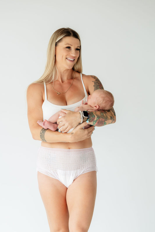 Mother holding newborn wearing Partum Panties disposable postpartum underwear